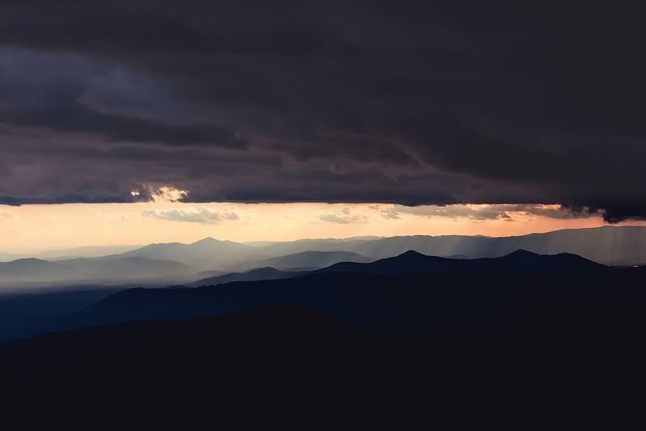 mountain range under cloudy sky, clouds and mountains during daytime HD wallpaper