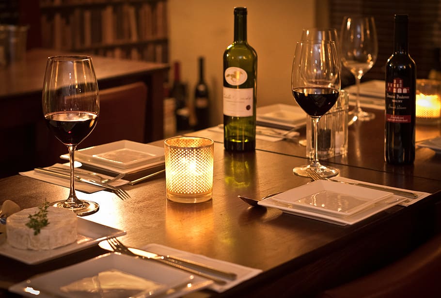 dinner setup on brown wooden table, bistro, wine, romantic, intimate