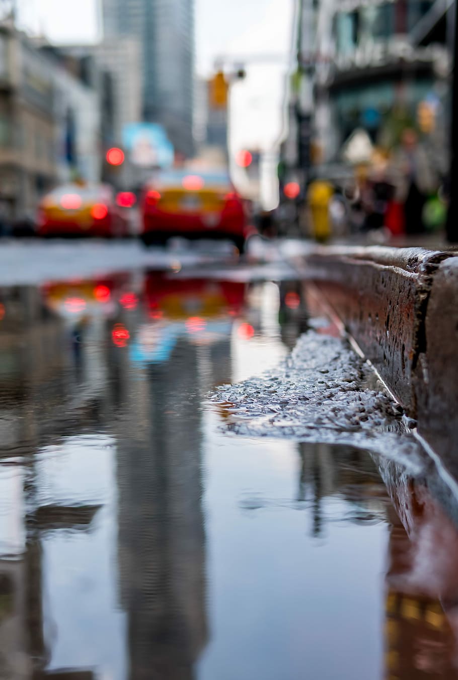 After the rain, water puddle near curb, road, street, reflection