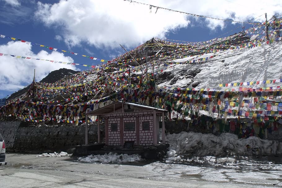 stage with buntings in front of alps photo, ladakh, mountain