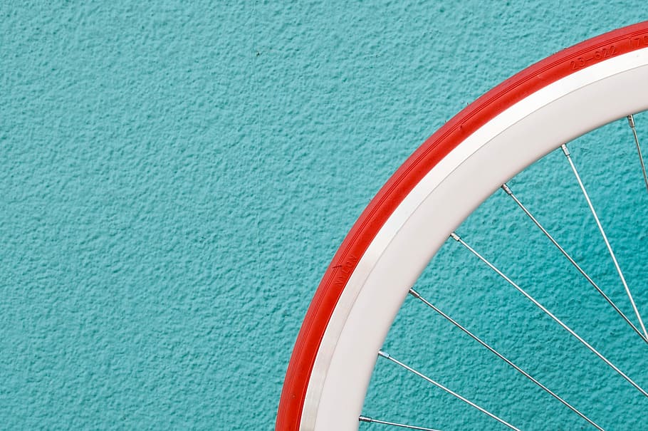 photo of red and white bike tire, white bicycle rim, gear, design