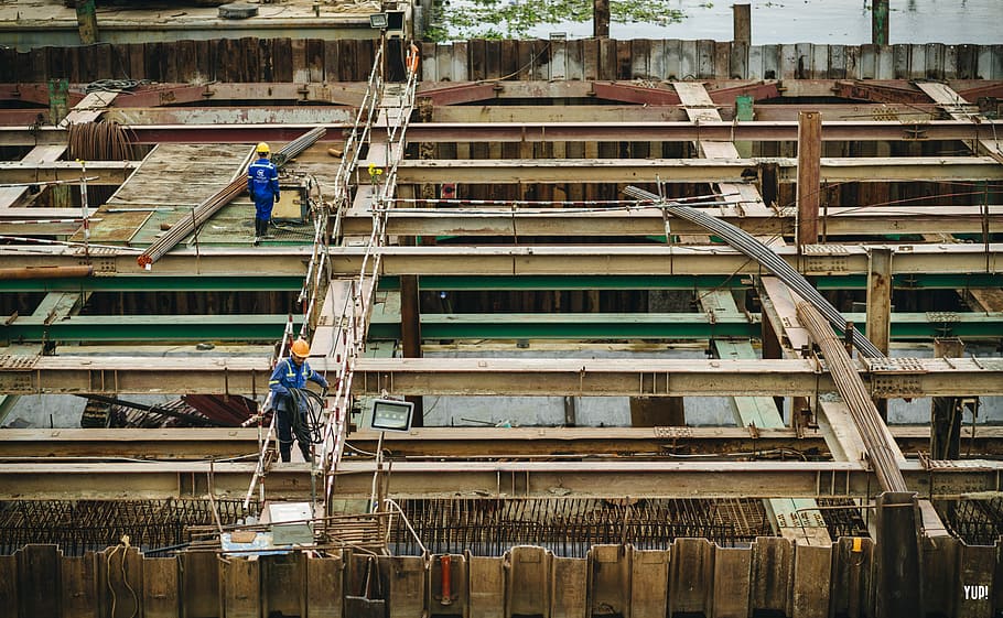aerial view of two person on top building, brown roof trusses HD wallpaper