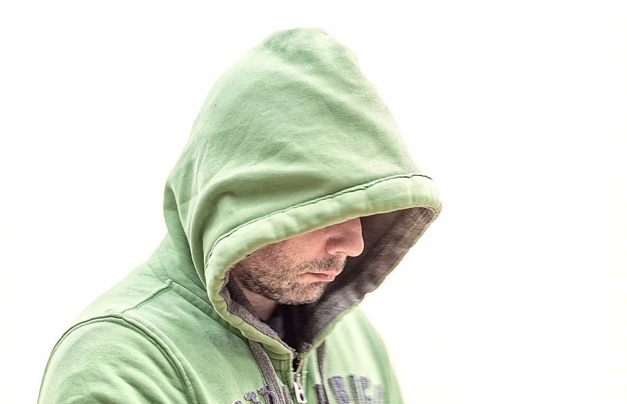 man wearing green hoodie looking down, cold, person, white background HD wallpaper