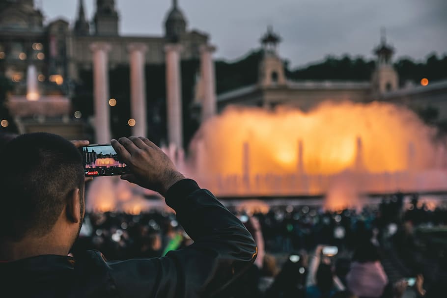 man capturing fountain at daytime, man in black leather jacket taking photo of outdoor fountain HD wallpaper