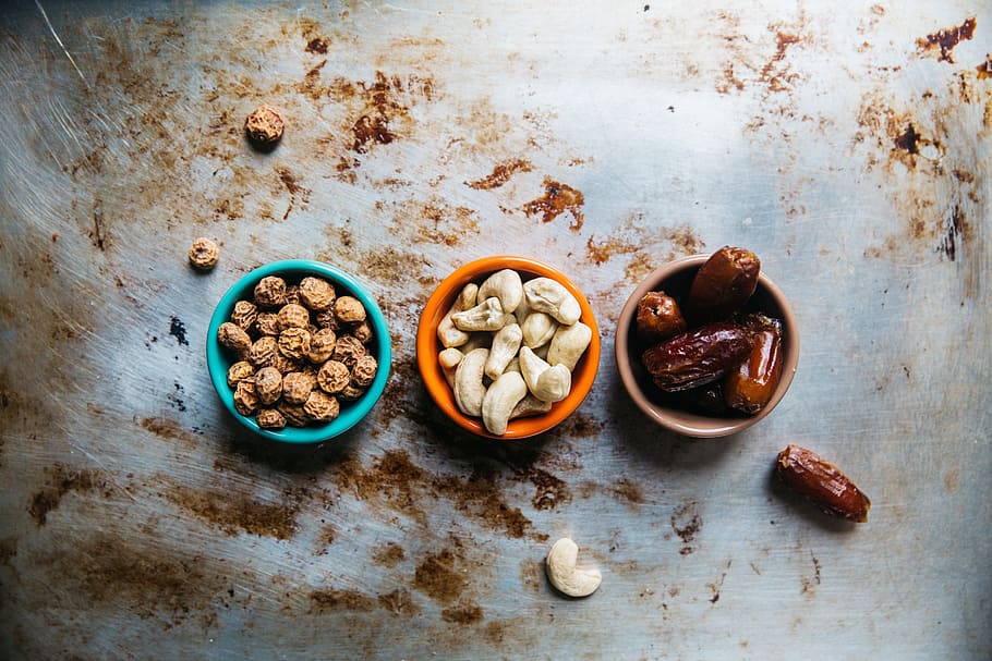 cashew, nuts, peanuts, prunes, bowl, raisins, table, dirt, food and drink HD wallpaper