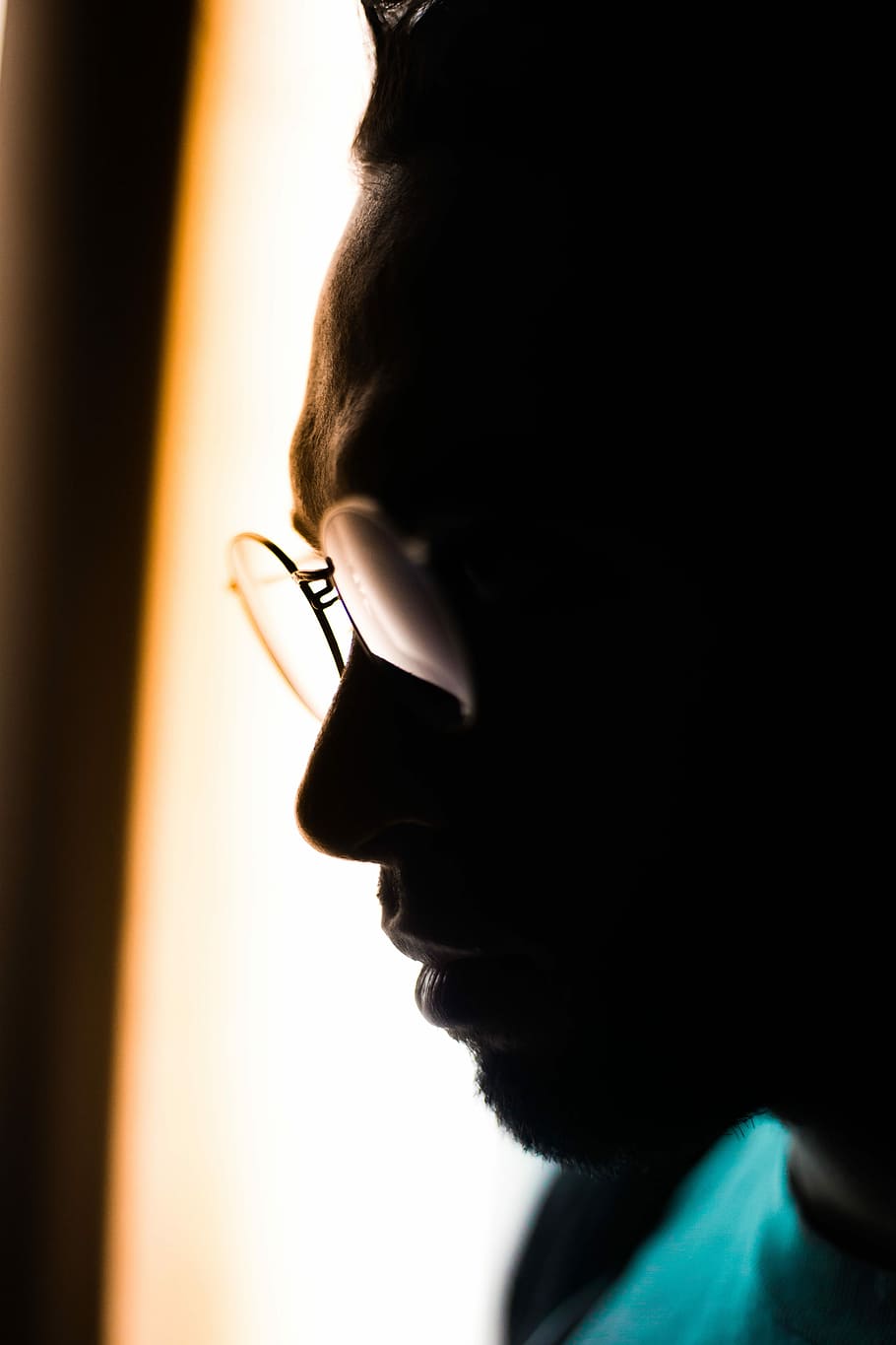 man wearing eyeglasses and teal crew-neck tops in close-up photography, silhouette photography of man wearing eyeglasses in room, HD wallpaper