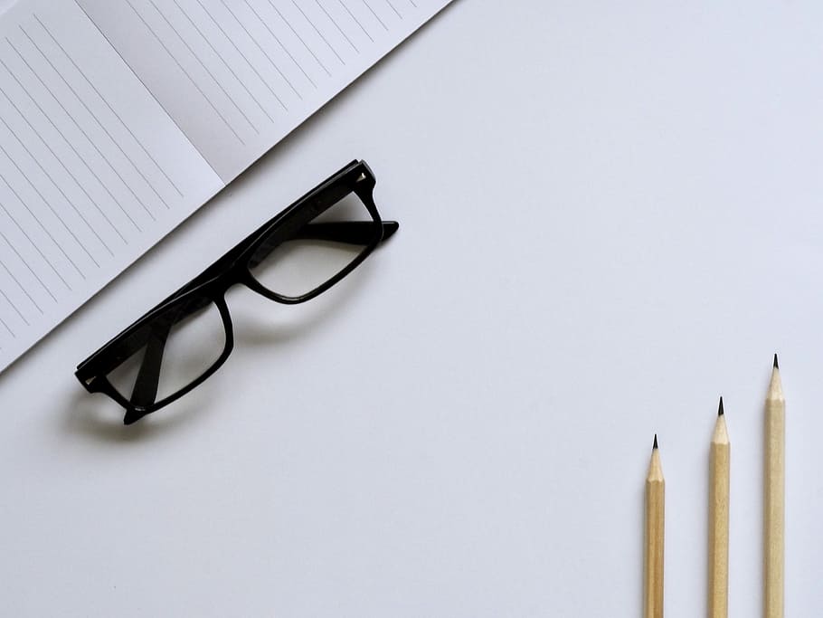 eyeglasses with black frames, eyeglasses with black frames beside notebook and pencils HD wallpaper
