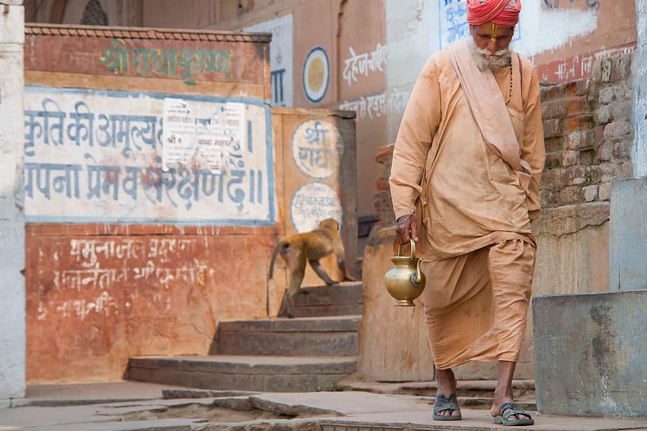 man carrying kettle walking on isle, india, incarnation, travel