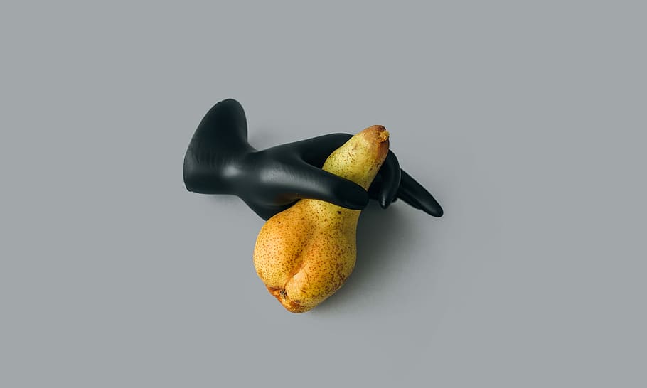 Unporn: Pear, yellow fruit and black mannequin hand, model, holding HD wallpaper