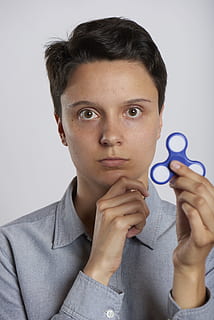 fidget spinner, holding, craze, one person, studio shot, indoors HD wallpaper