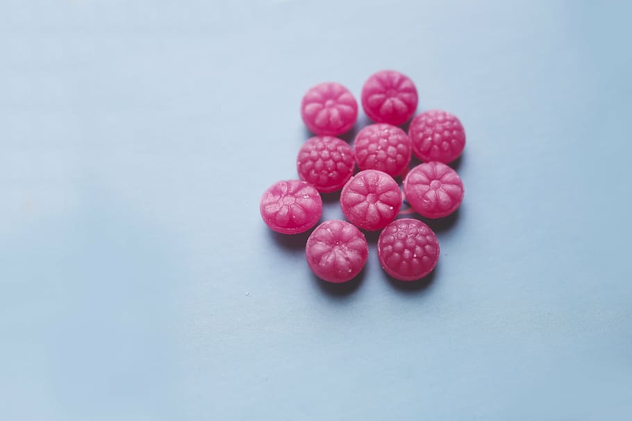 round pink candies on blue panel, candy, sugar, sweet, baby blue HD wallpaper