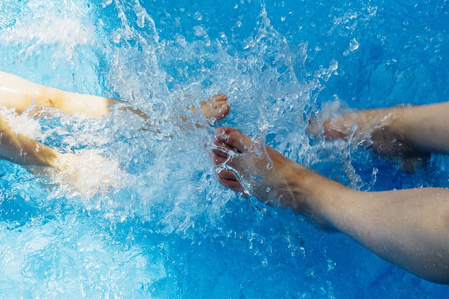 two pairs of feet splashing water, summer, cooling, jump into the water