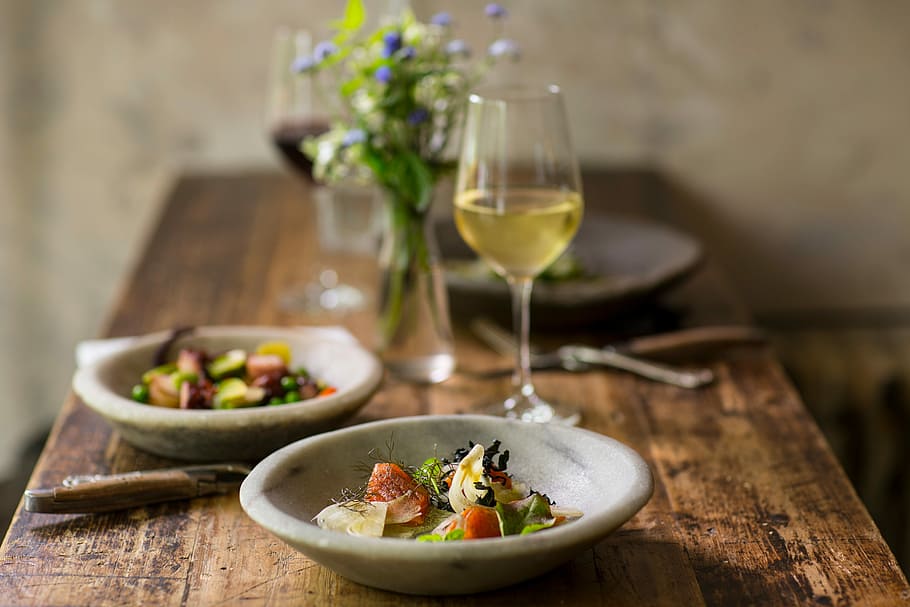 tilt shift photo of vegetables on round saucer beside glass of champagne on wooden tabletop HD wallpaper