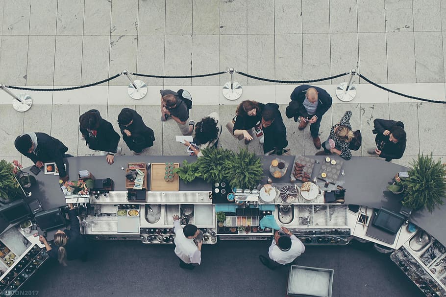 aerial view photography of people lining-up at the food counter, people standing near buffet counter HD wallpaper