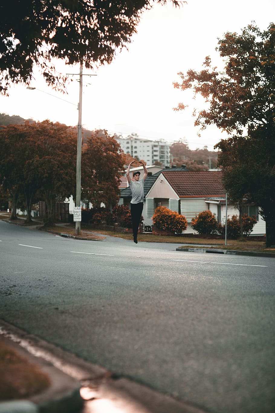 man jumped on asphalt road, shallow focus photography of man jumping on road during daytime HD wallpaper