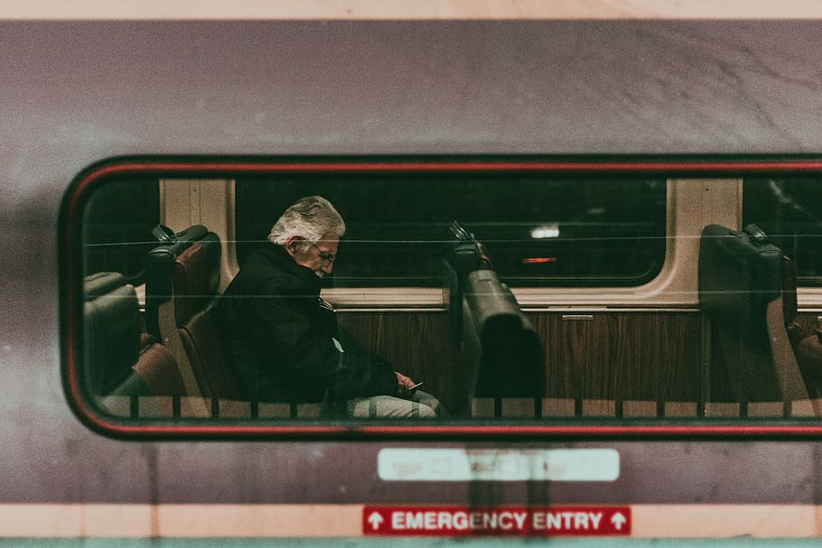 man sitting inside vehicle, train, travel, transportation, people
