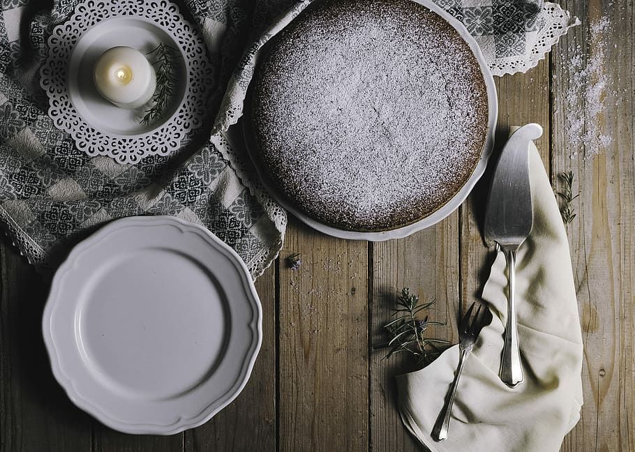 pie on white ceramic plate beside white tealight candle and cake server, white ceramic saucer near silver fork HD wallpaper