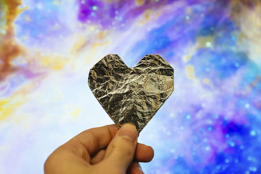person holding silver heart paper decor, design, hand, wrinkled HD wallpaper