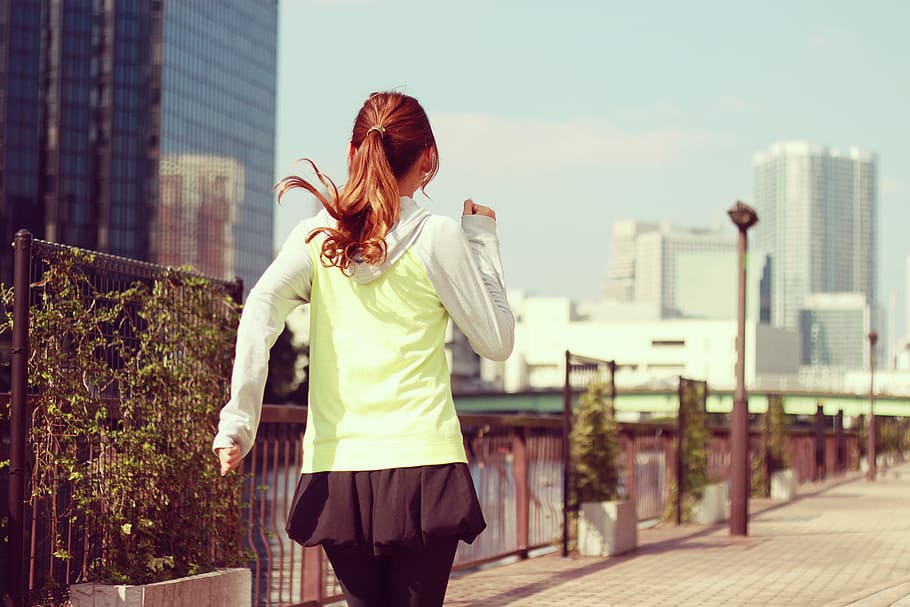 girl wearing green top while runninng, women, outdoors, city HD wallpaper