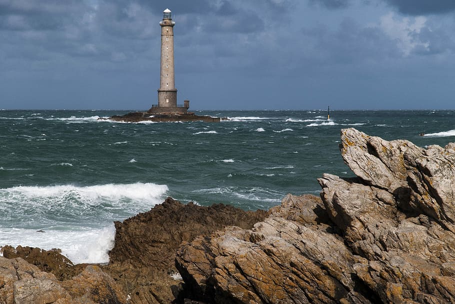 landscape photography of lighthouse near body of water, gray concrete lighthouse on island HD wallpaper