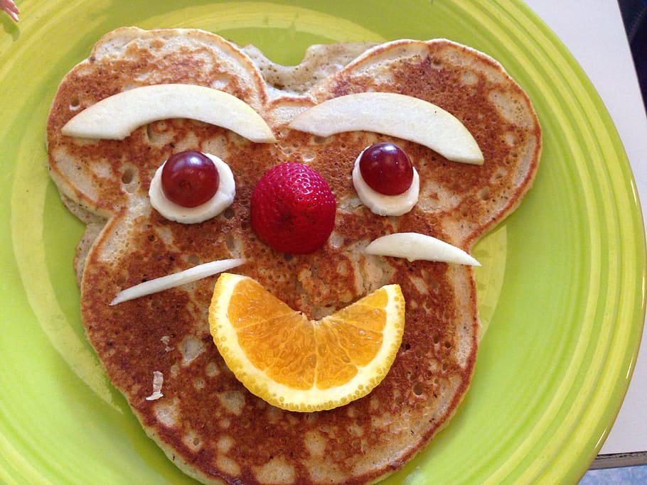 closeup photo of pancake with fruit, face, breakfast, brunch