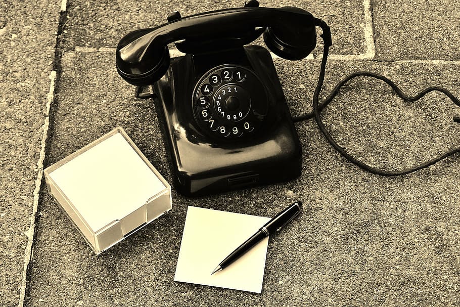 black rotary phone on black surface, old, year built 1955, bakelite