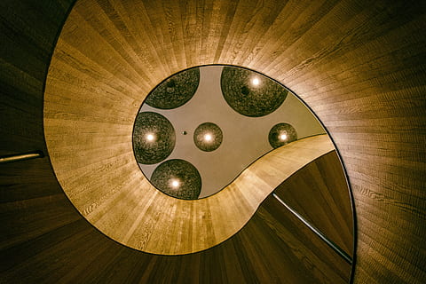 Lights above a spiral staircase in a designer hotel in London, England HD wallpaper
