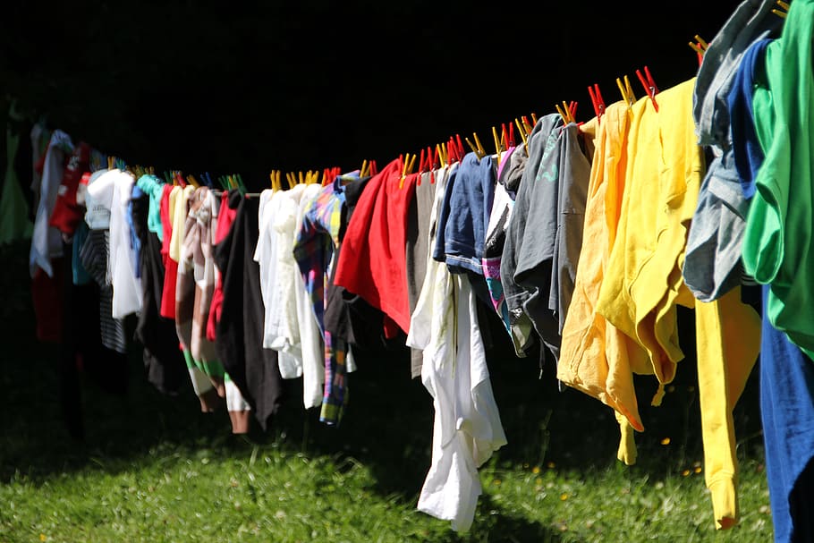 photo of multicolored clothes hanged during daytime, clothes line