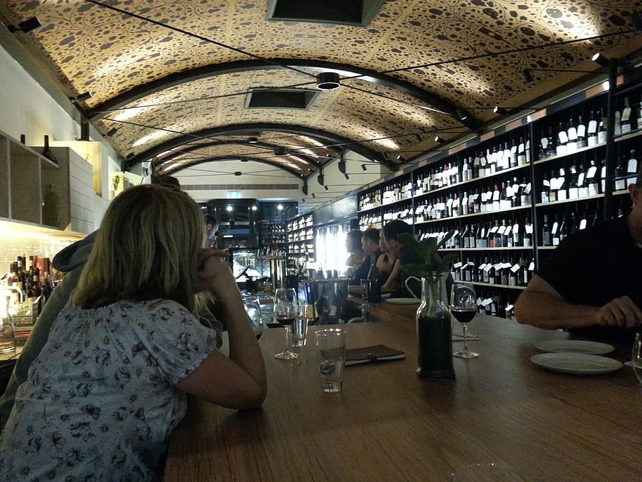 people sitting by the table inside bar with ceiling lights on HD wallpaper