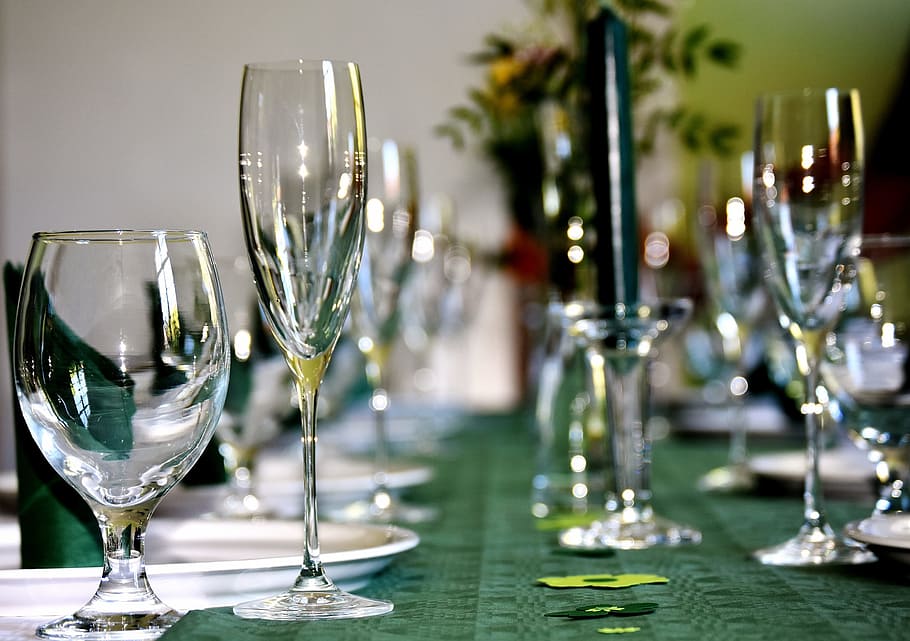 close-up photography of assorted clear glasses on green table