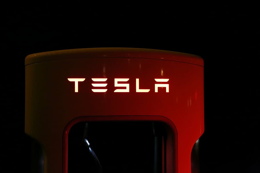 close-up photography of red Tesla vehicle fob, supercharger, battery, HD wallpaper