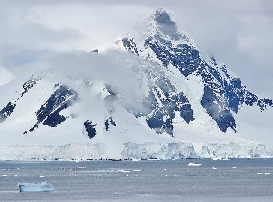 gray icy mountain covered with clouds, antarctica, sea, ocean