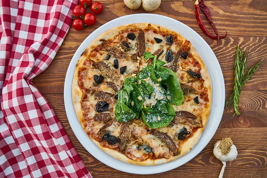 cooked food with toppings, pizza, meat, dough, greens, olives