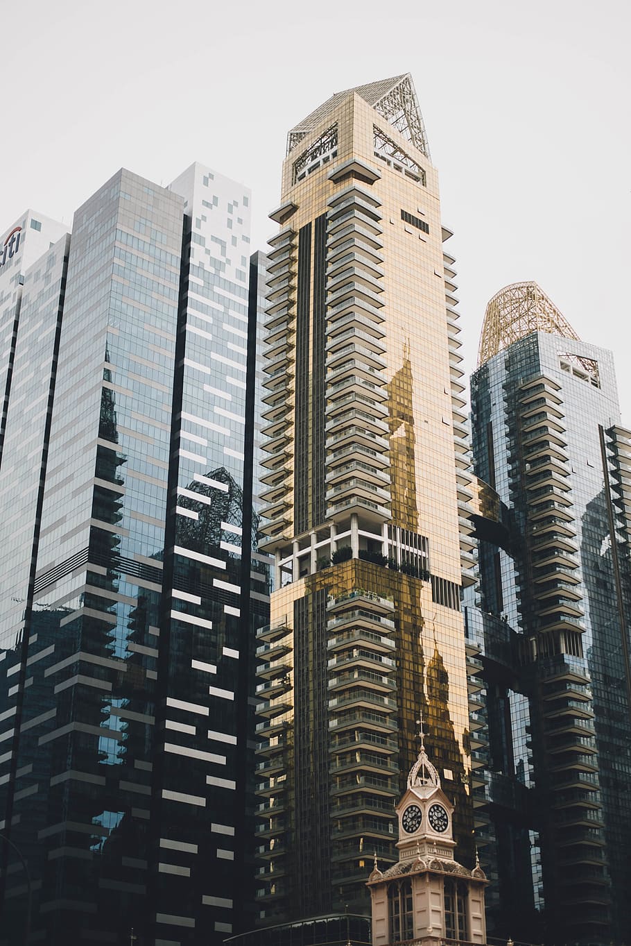 brown glass-panel building, photo of gold-colored building during daytime HD wallpaper