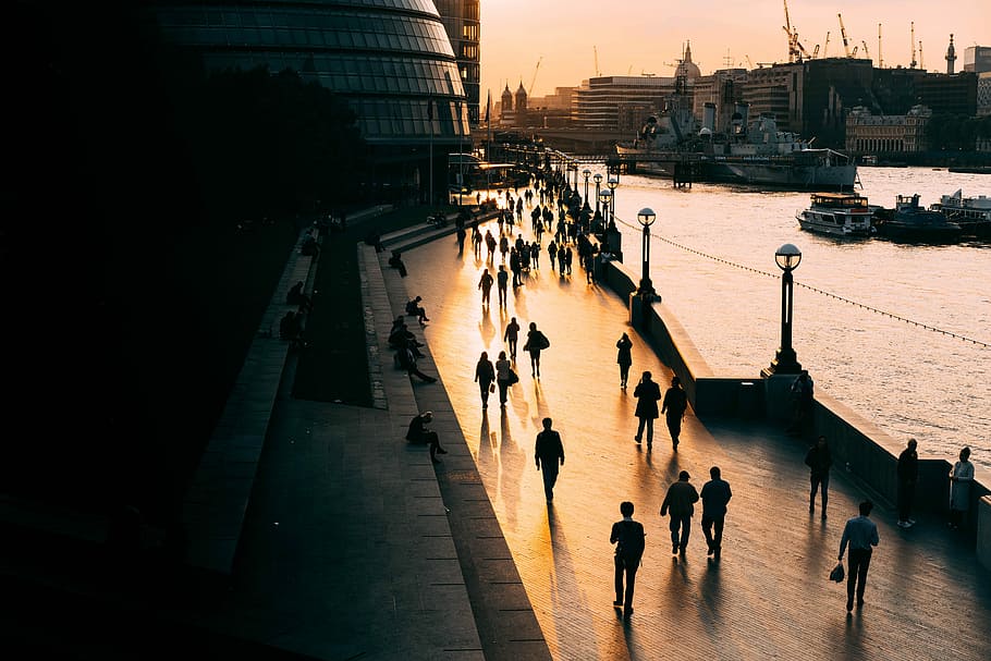 people walking on road near body of water, people walking on street along side water HD wallpaper