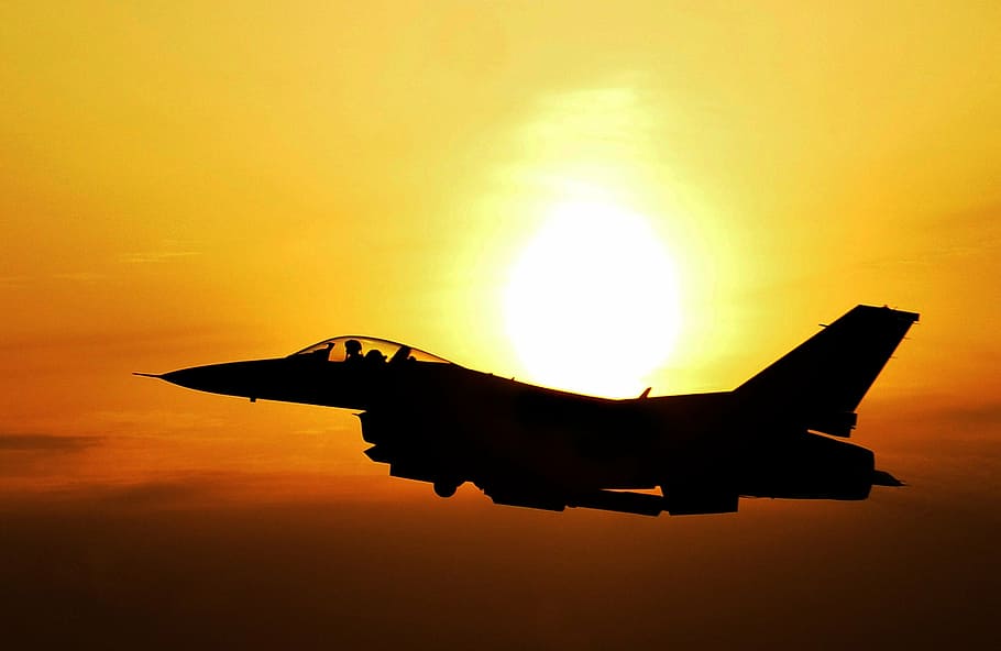 timelapse photography of black fighter plane during golden hour HD wallpaper