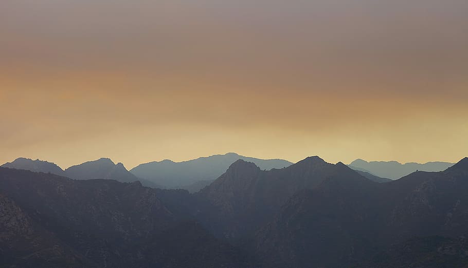silhouette of mountains during sunset, landscape photography of grey mountains with fog