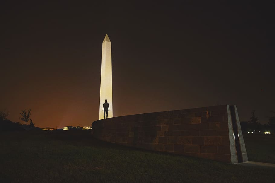 man standing on front of Obelisk in Egypt, silhouette man standing beside tower HD wallpaper