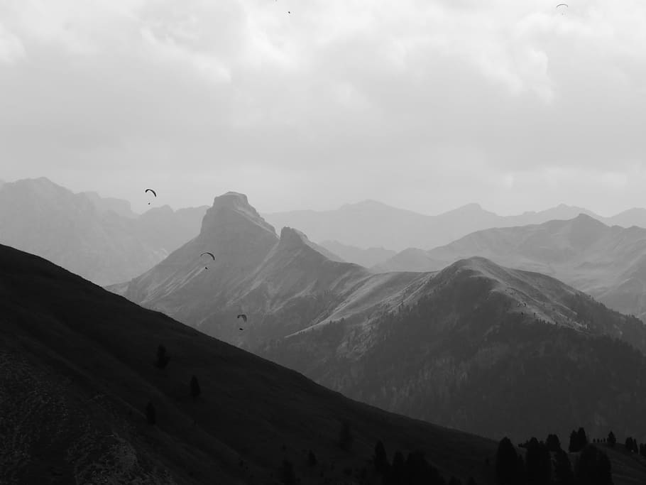 grayscale photo of mountains, south tyrol, dolomites, paragliders