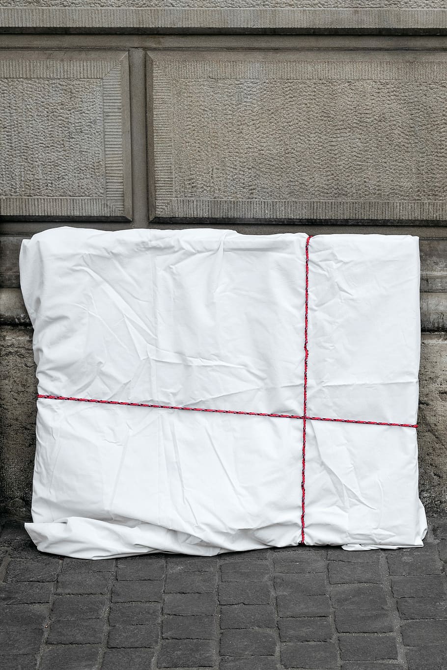 white and red textile on gray bricked floor, rectangular white covered textile HD wallpaper