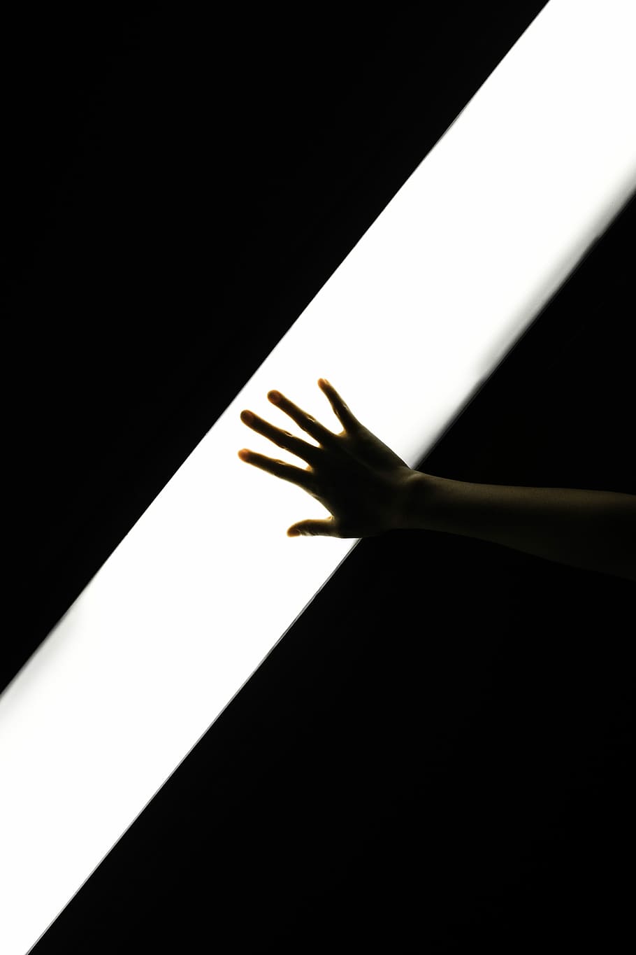 person's right hand tap on white light in dark room, stripe HD wallpaper