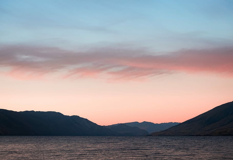 mountains near body of water, mountain near ocean under blue sky HD wallpaper