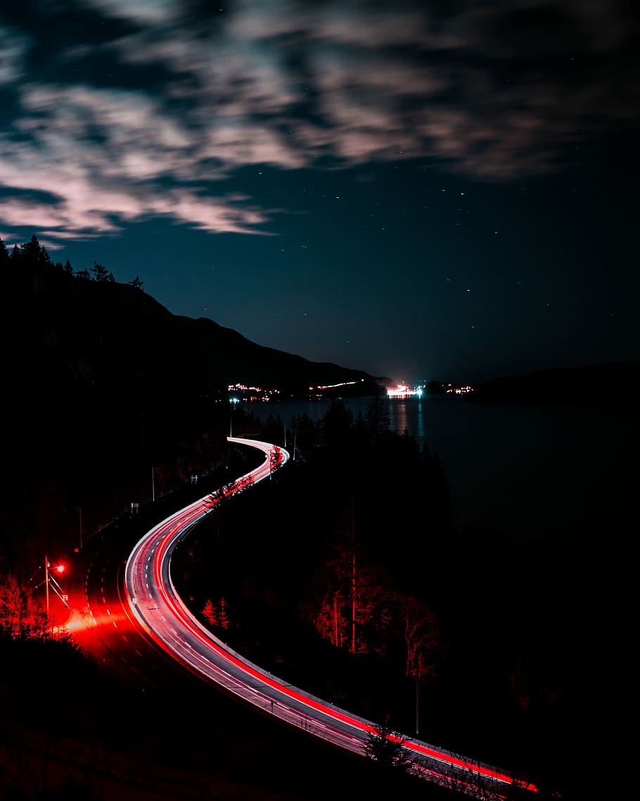 photo of vehicle lights on road, timelapse photography of road near body of water at nighttime HD wallpaper
