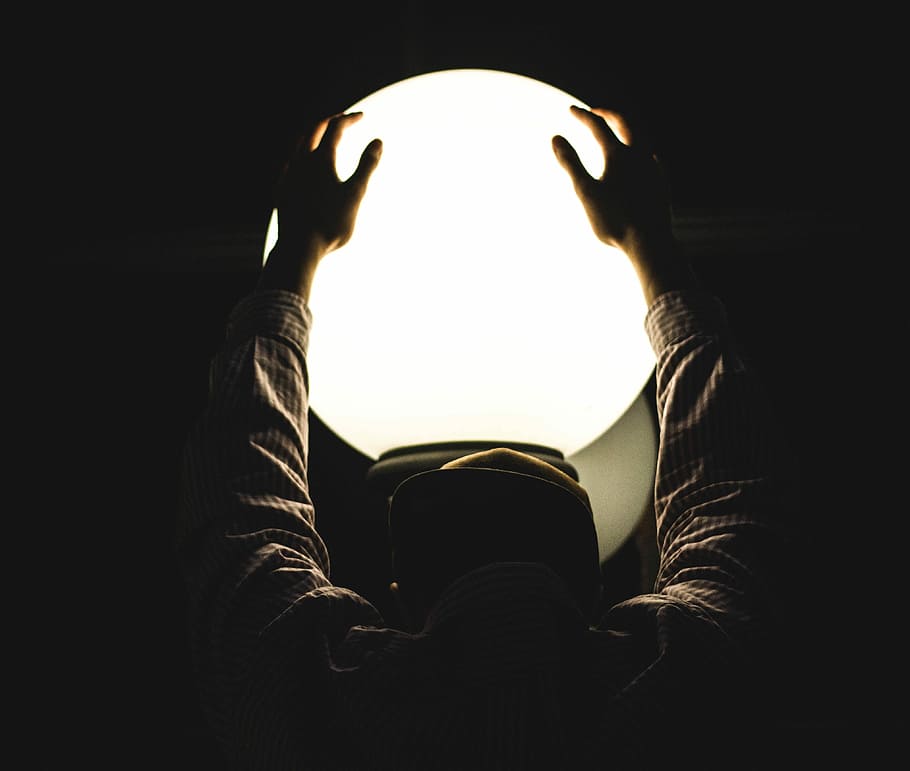 person holding round glass window, closeup photo of person's hand holding lighted ball HD wallpaper