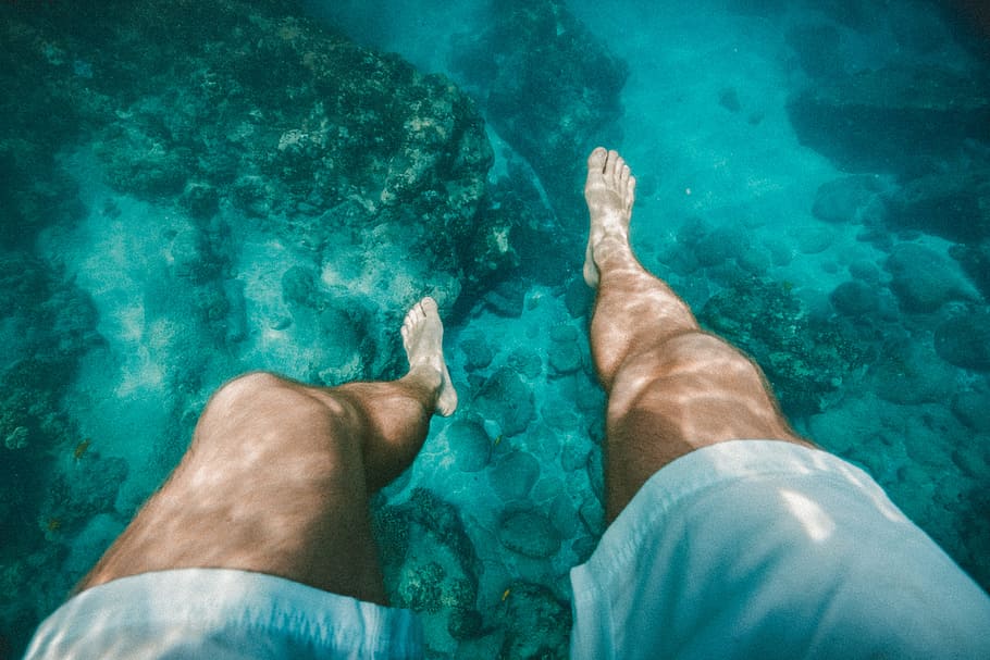 underwater photography of a person wearing white shorts, man in white short HD wallpaper