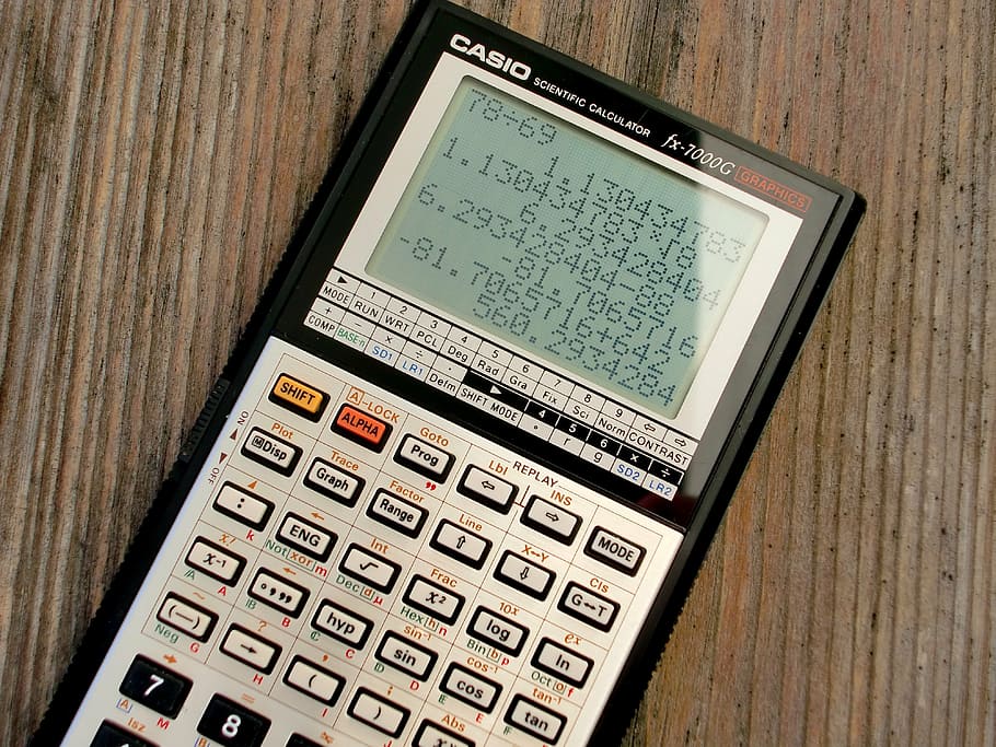 black and gray Casio graphing calculator on brown surface, casio fx-7000 g, HD wallpaper