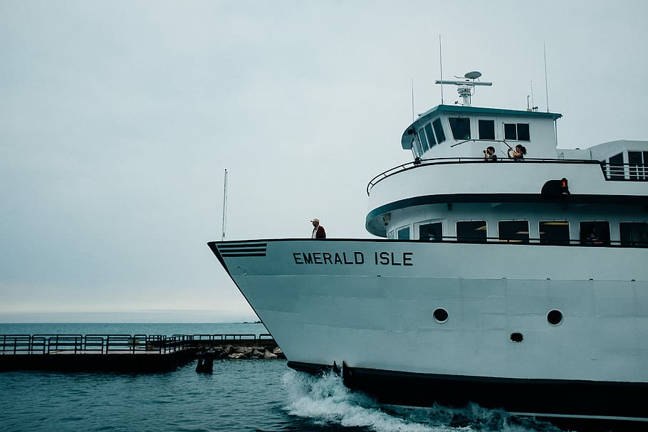 white Emerald Isle boat near dock at daytime, man standing on Emerald Isle ship, HD wallpaper