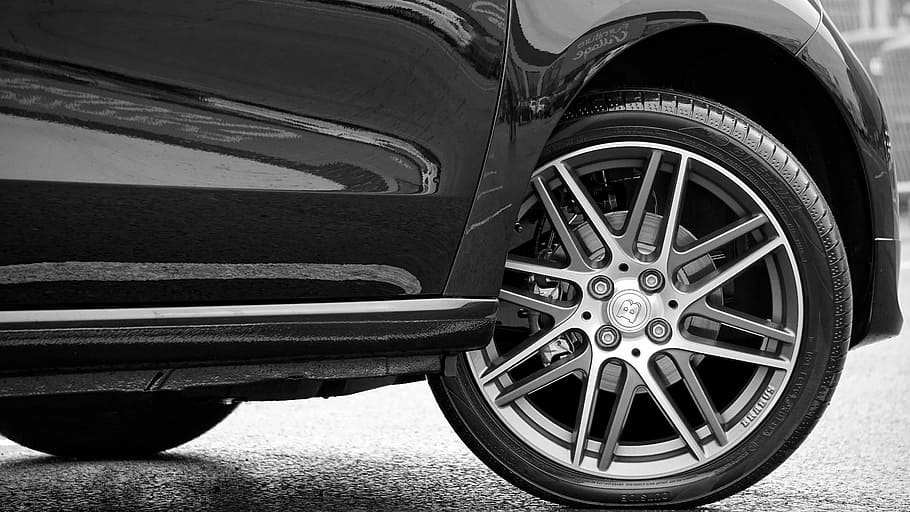 closeup photography of black car with gray multispoke vehicle wheel and tire