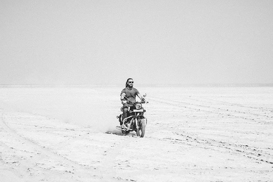 grayscale photo of man riding motorcycle, sand, beach, white HD wallpaper