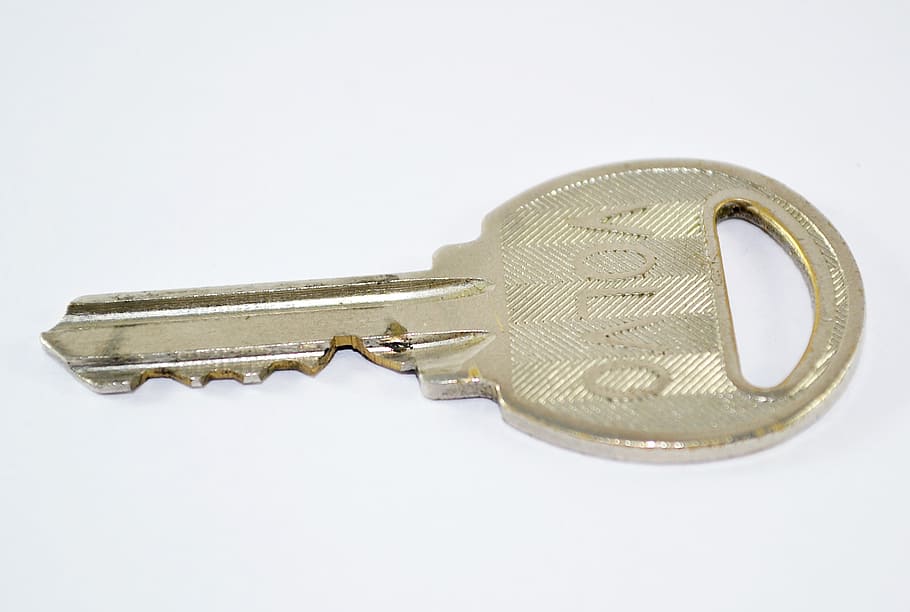 brass-colored Volvo key on white surface, lock, door, protection HD wallpaper